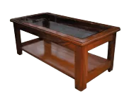 A wooden table with a glass top and a shelf