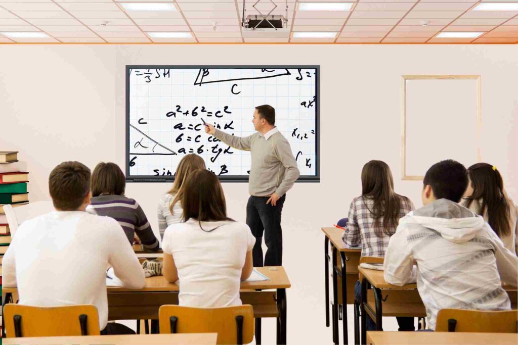 teacher teach the students using interactive flat panel display in classroom