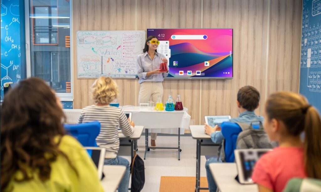 A teacher teach a students in  smart classroom