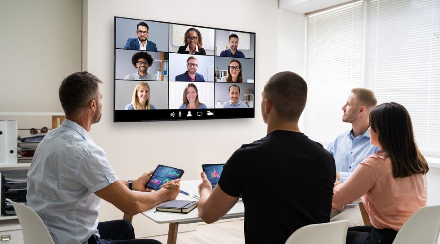 some peoples make a zoom meeting on interactive flat panel display