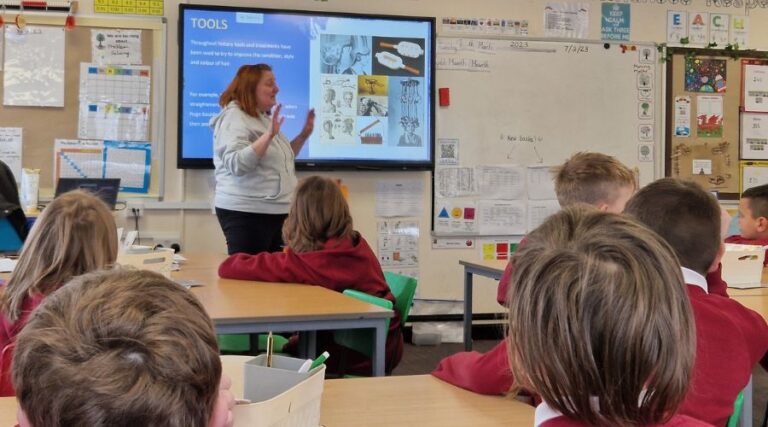 Teacher Teach a student on interactive whiteboard in the classroom
